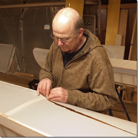 Dave is sewing the bow of his boat